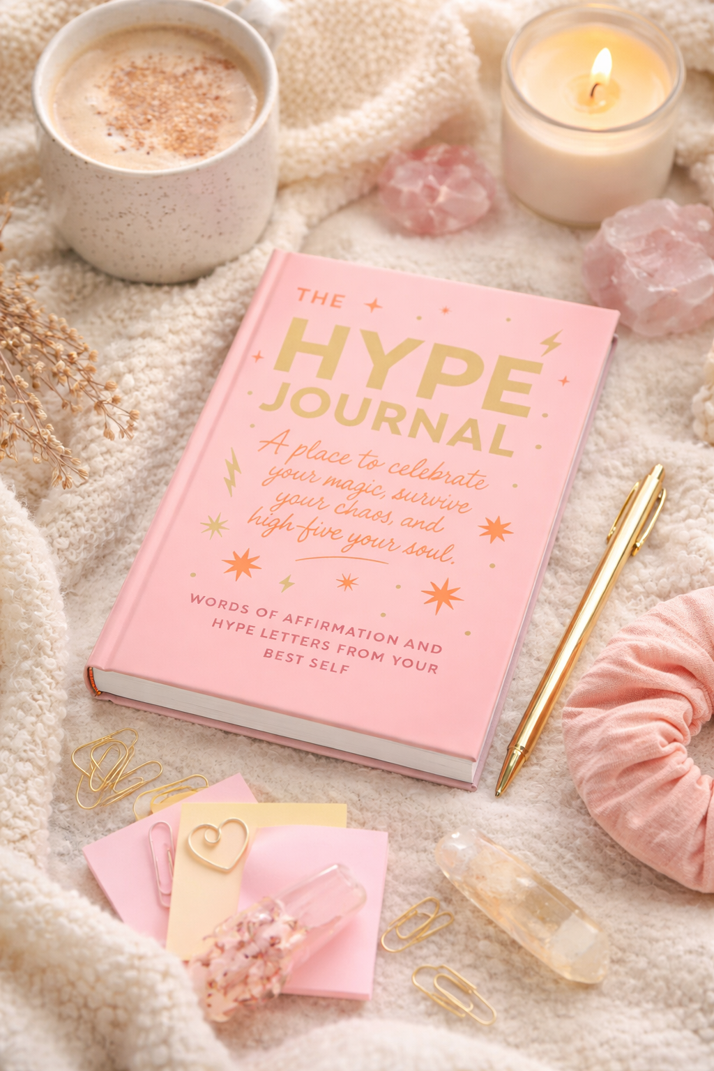 The Hype Journal displayed in a soft flatlay with flowers and candle on white background