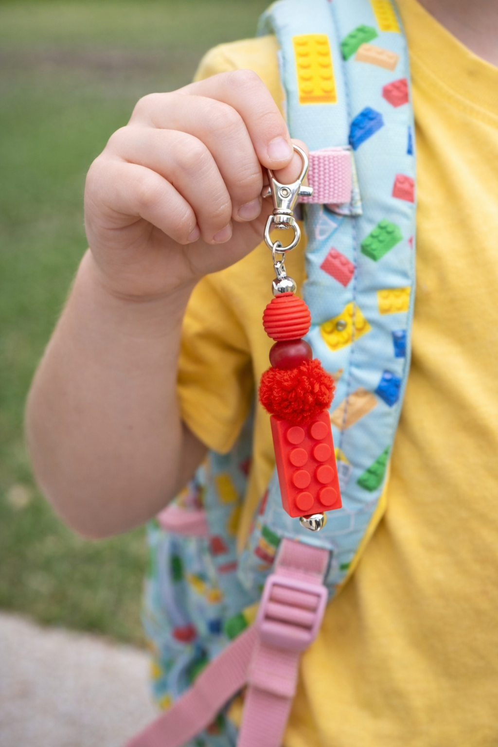 Hand holding Coping Life handmade fidget keychain showing colorful bead textures and length